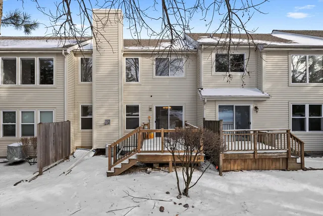 a view of a house with a patio and a yard
