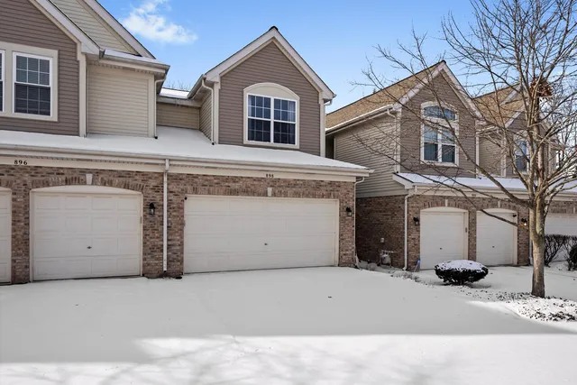 a view of a house with a snow in the yard