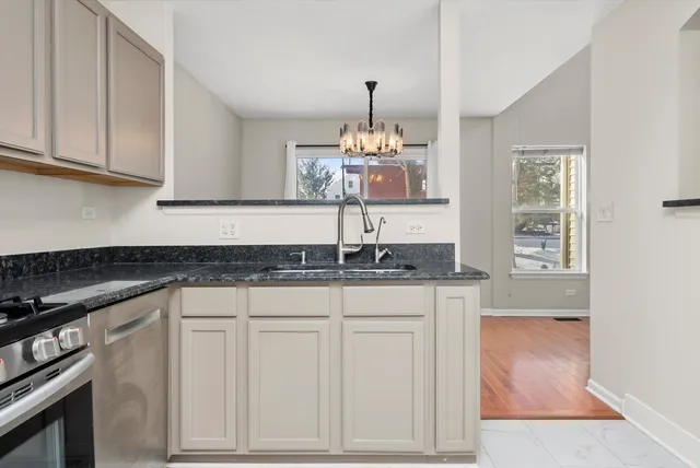 a kitchen with granite countertop white cabinets and a granite counter tops