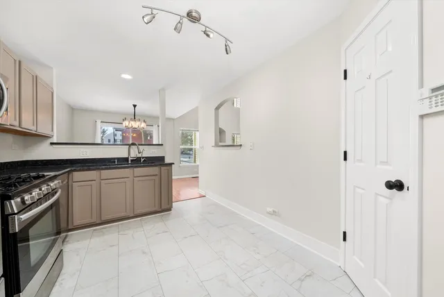 a large kitchen with cabinets and stainless steel appliances
