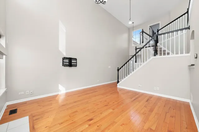 a view of a hallway with wooden floor and entryway
