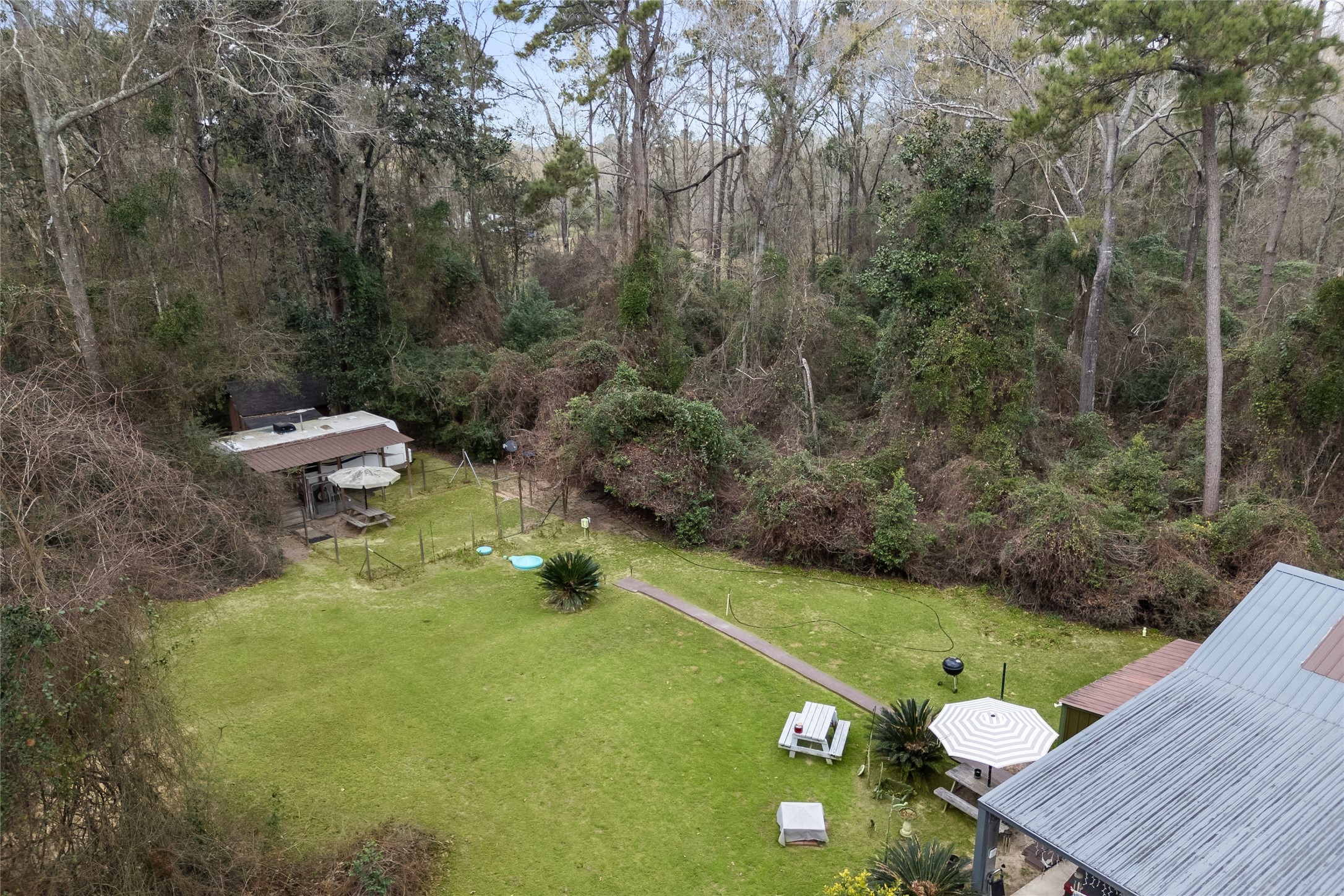31601 Huffman Cleveland Road Huffman, TX 77336 - Photo 15 of 38 a view of a wooden deck and a backyard