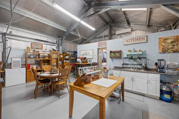 a bedroom with a bed and a flat tv screen on dresser