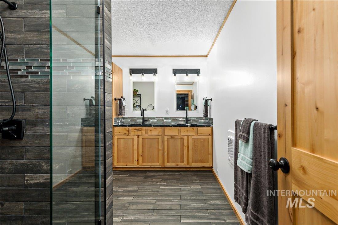 79 Sunset Loop Cascade, ID 83611 - Photo 21 of 44 Dual vanity with light wood cabinetry and dark countertops
