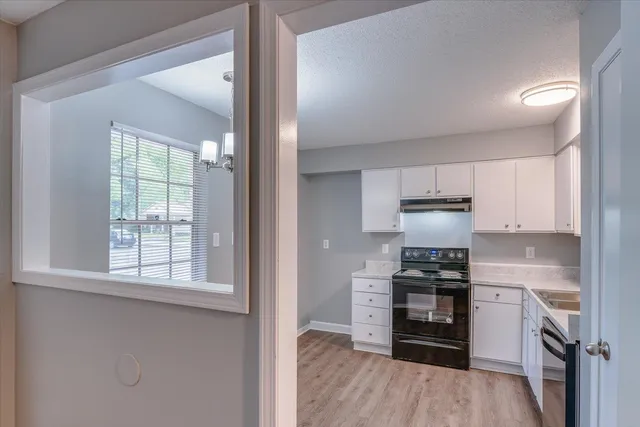 a kitchen with stainless steel appliances a stove a sink and a refrigerator