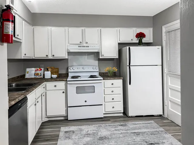 a kitchen with cabinets appliances and a counter space