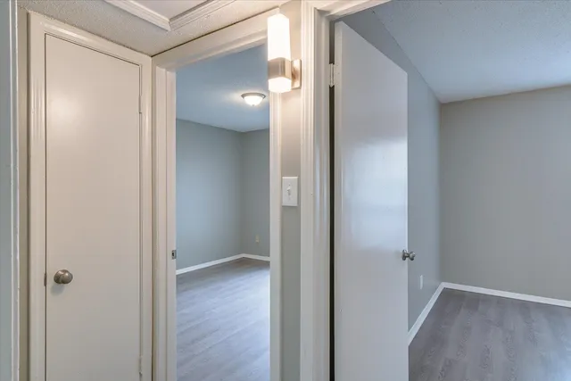 a view of a hallway with wooden floor