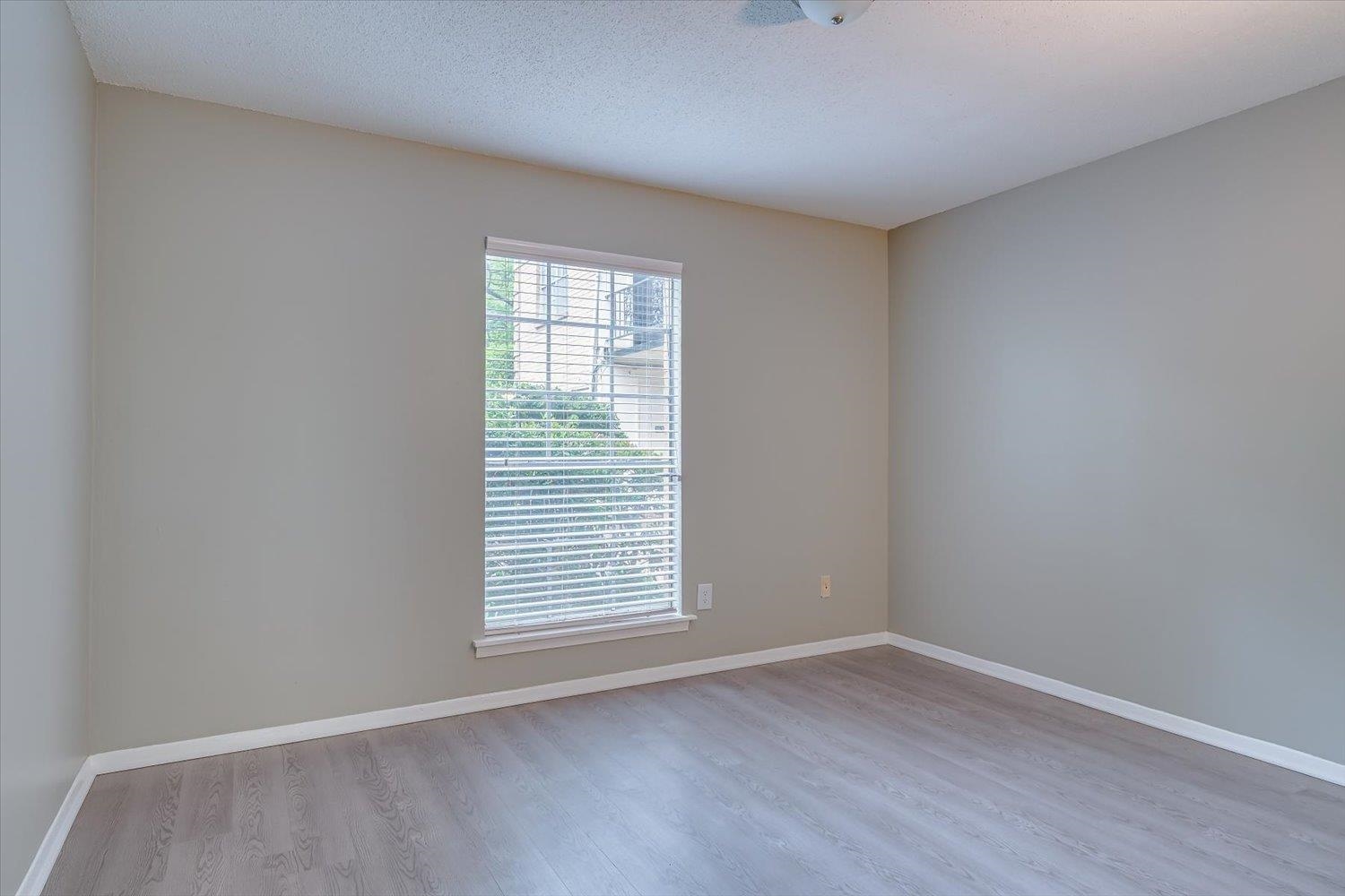 3636 Spottswood Avenue, Unit 1 Memphis, TN 38111 - Photo 17 of 32 an empty room with wooden floor and windows