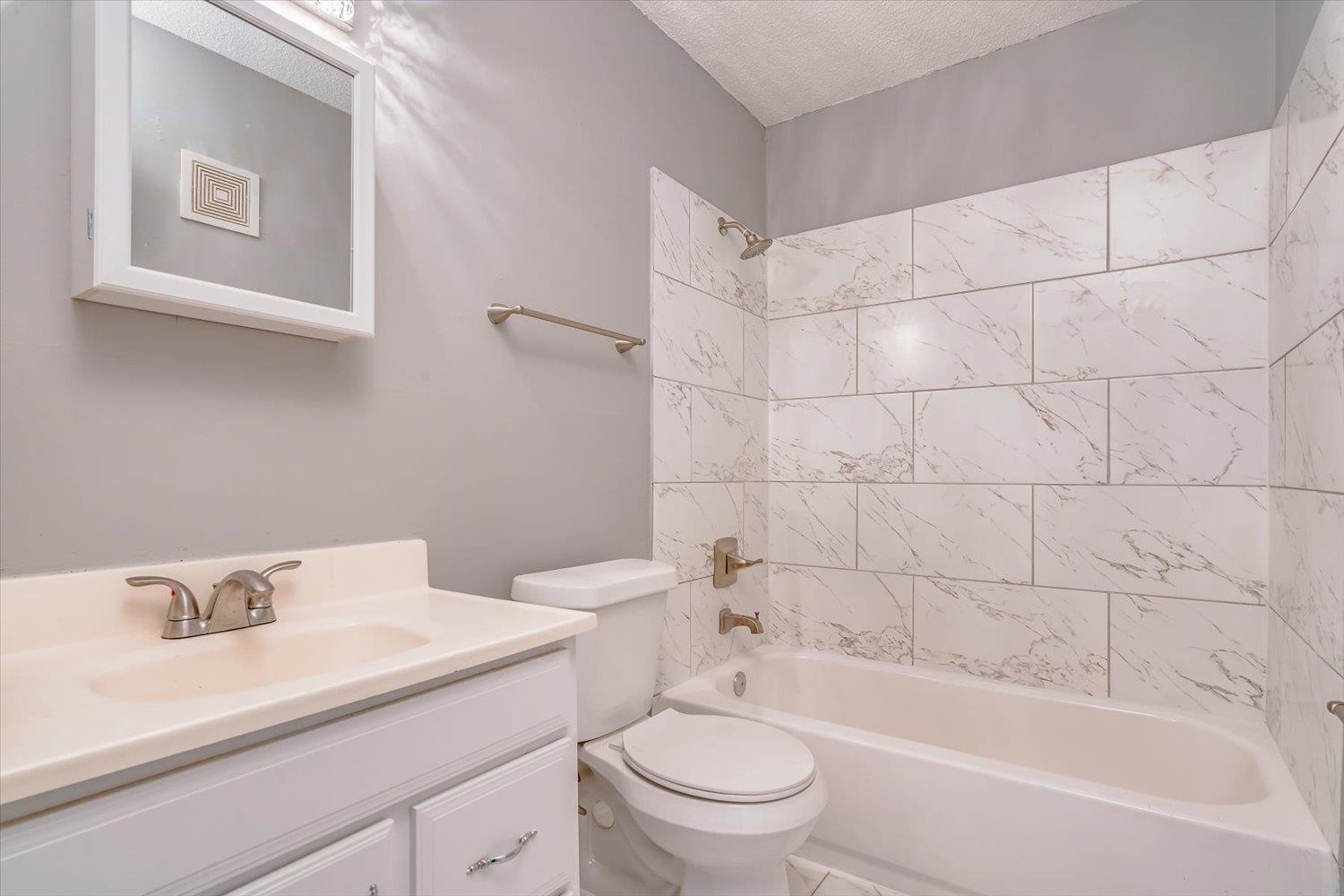 3636 Spottswood Avenue, Unit 1 Memphis, TN 38111 - Photo 22 of 32 a bathroom with a sink mirror toilet and bathtub