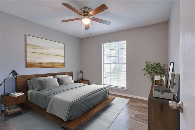 a bedroom with a large bed and a chandelier
