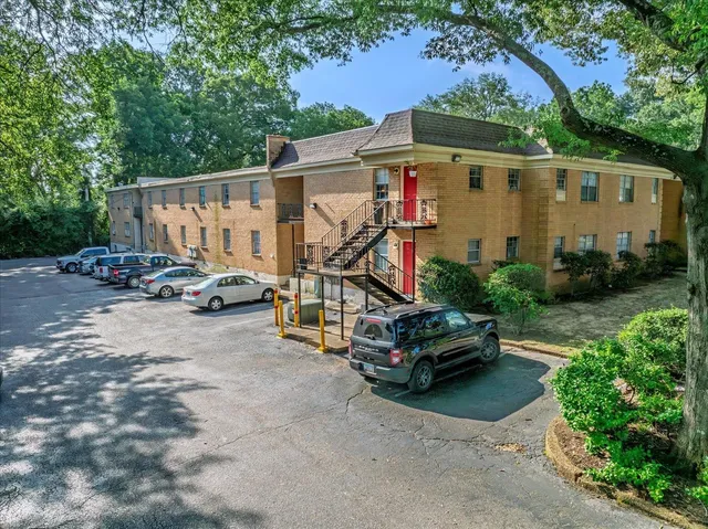 a car parked in front of a white house
