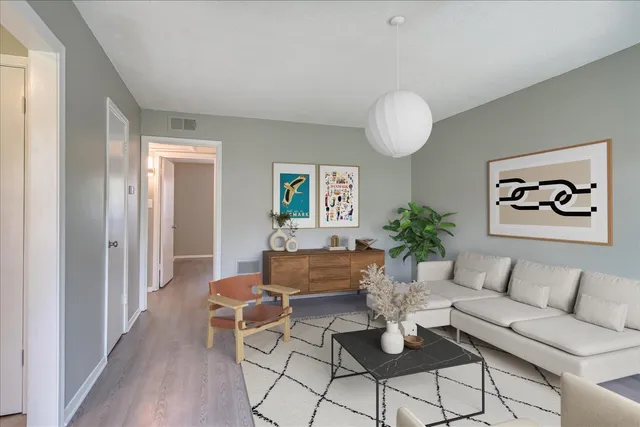 a living room with furniture and a chandelier