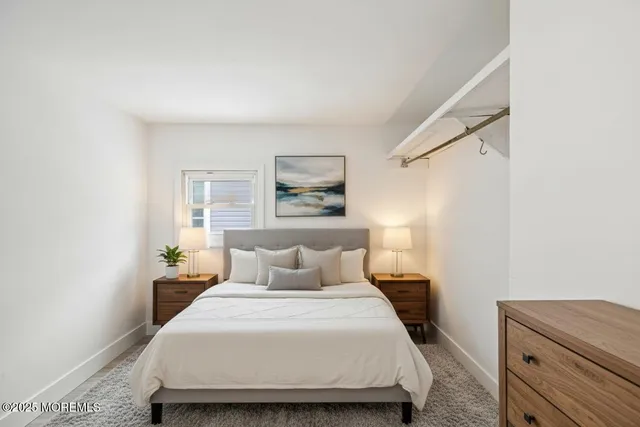 a bedroom with a bed and a potted plant