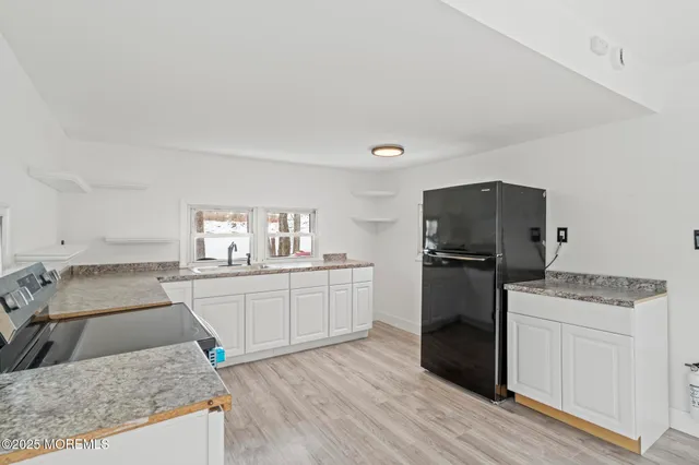 a kitchen with a stove a sink and a refrigerator