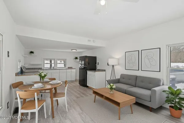 a kitchen with white cabinets and window