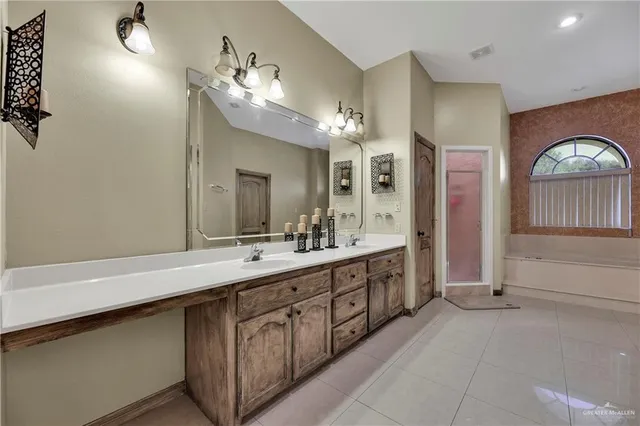 a spacious bathroom with a double vanity sink and a mirror