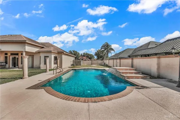 a front view of house with yard and swimming pool
