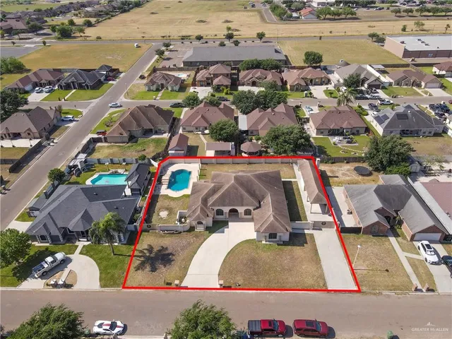 an aerial view of houses with swimming pool