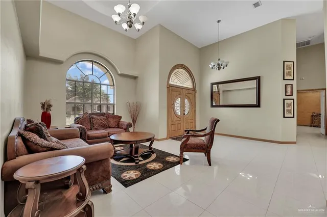 a living room with furniture and a chandelier