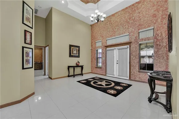 a living room with furniture and a chandelier