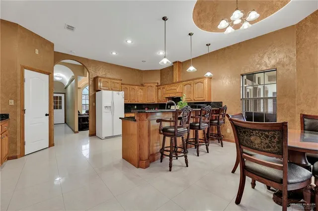 a view of kitchen with furniture and chandelier