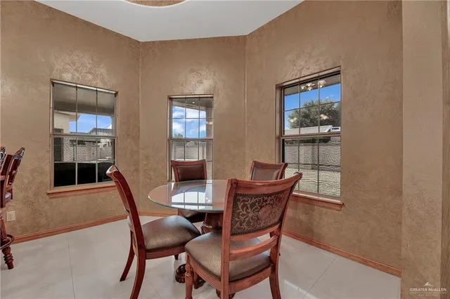 a dining room with furniture and window