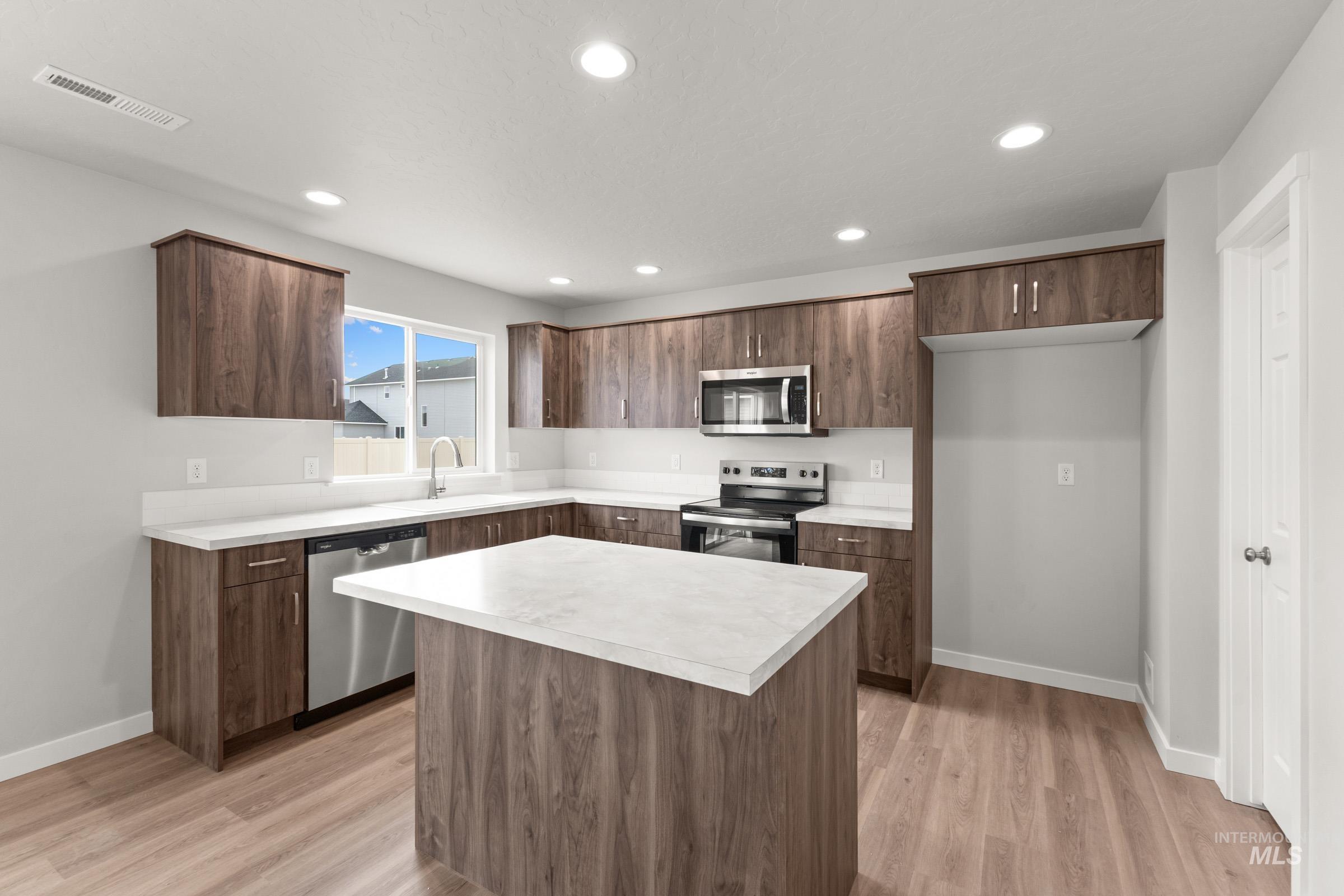 461 Waverly Avenue Middleton, ID 83644 - Photo 3 of 22 Kitchen featuring stainless steel appliances, light countertops, light wood-type flooring, modern cabinets, and a kitchen island