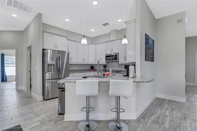 a kitchen with refrigerator and cabinets