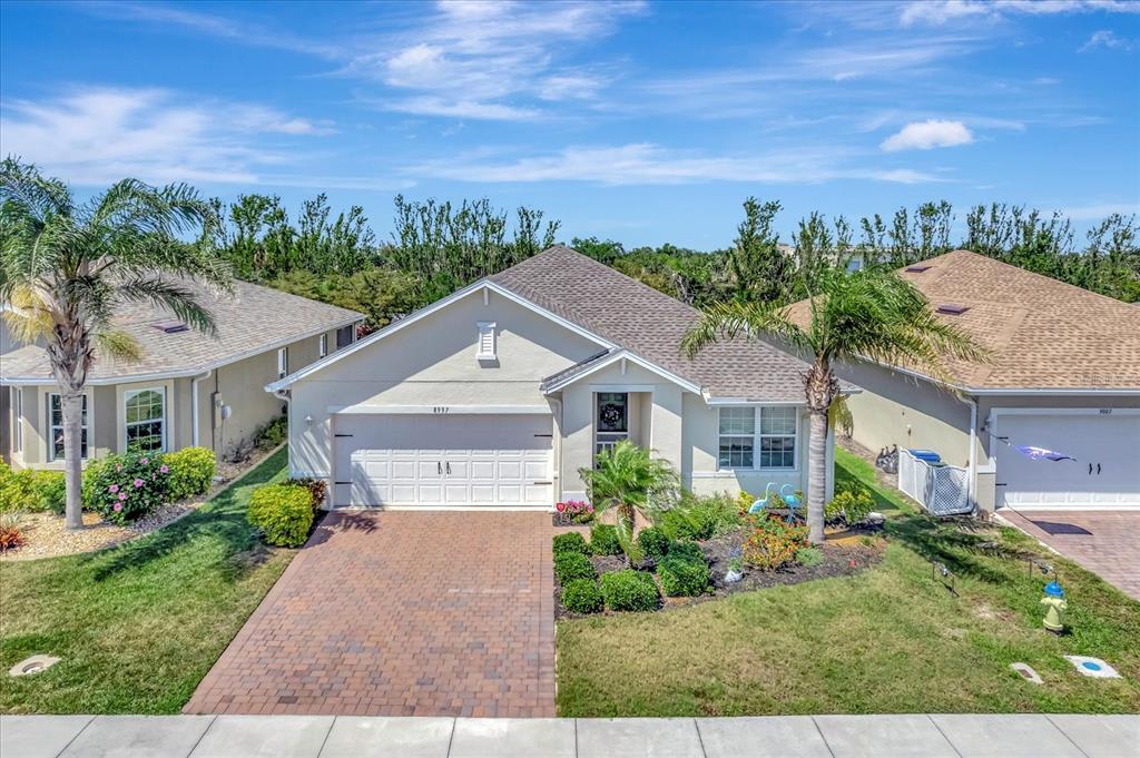 8997 Excelsior Loop Venice, FL 34293 - Photo 1 of 48 front view of a house with a garden