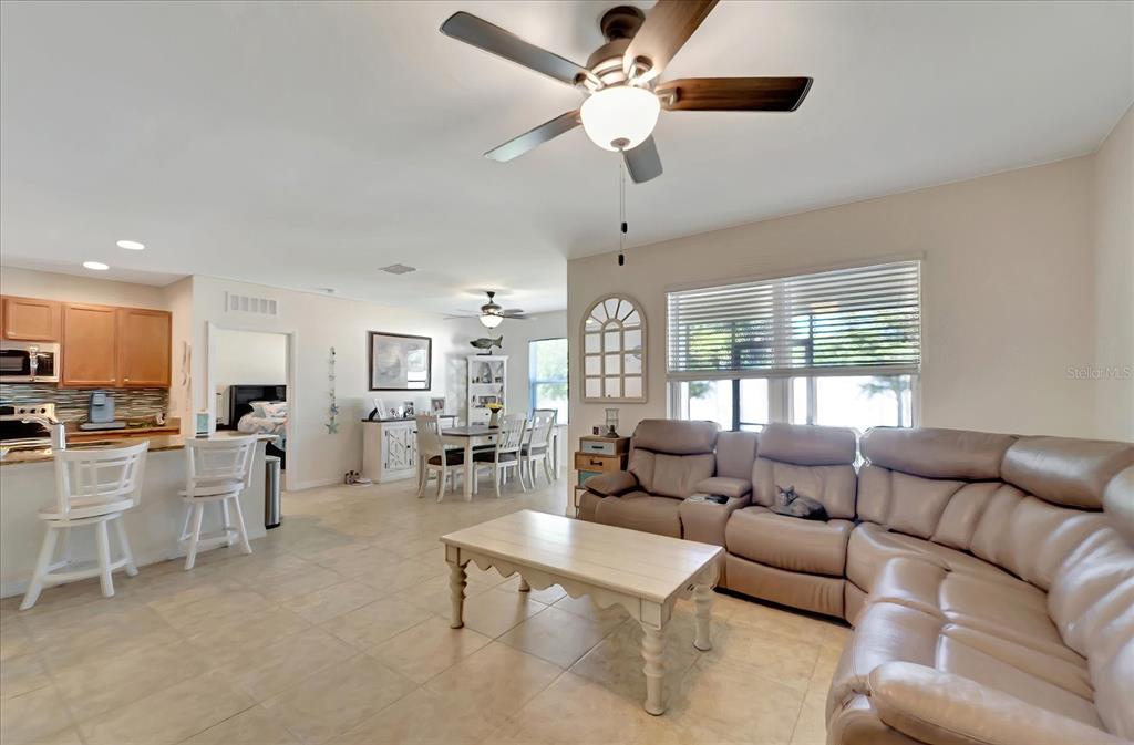 8997 Excelsior Loop Venice, FL 34293 - Photo 18 of 48 a living room with furniture ceiling fan and a window
