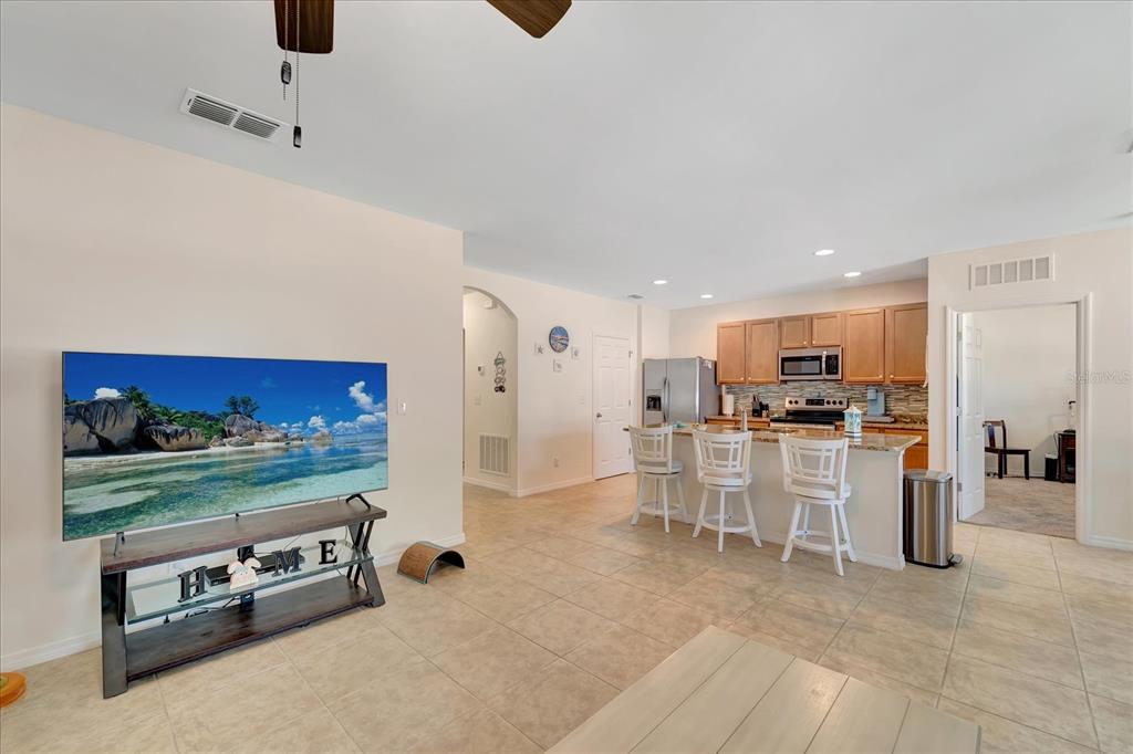 8997 Excelsior Loop Venice, FL 34293 - Photo 19 of 48 a kitchen with stainless steel appliances kitchen island granite countertop a refrigerator and a stove