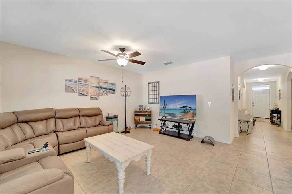 8997 Excelsior Loop Venice, FL 34293 - Photo 20 of 48 a living room with furniture and a chandelier