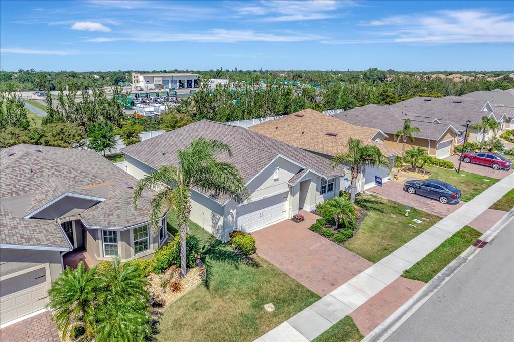 8997 Excelsior Loop Venice, FL 34293 - Photo 2 of 48 an aerial view of multiple houses with a yard