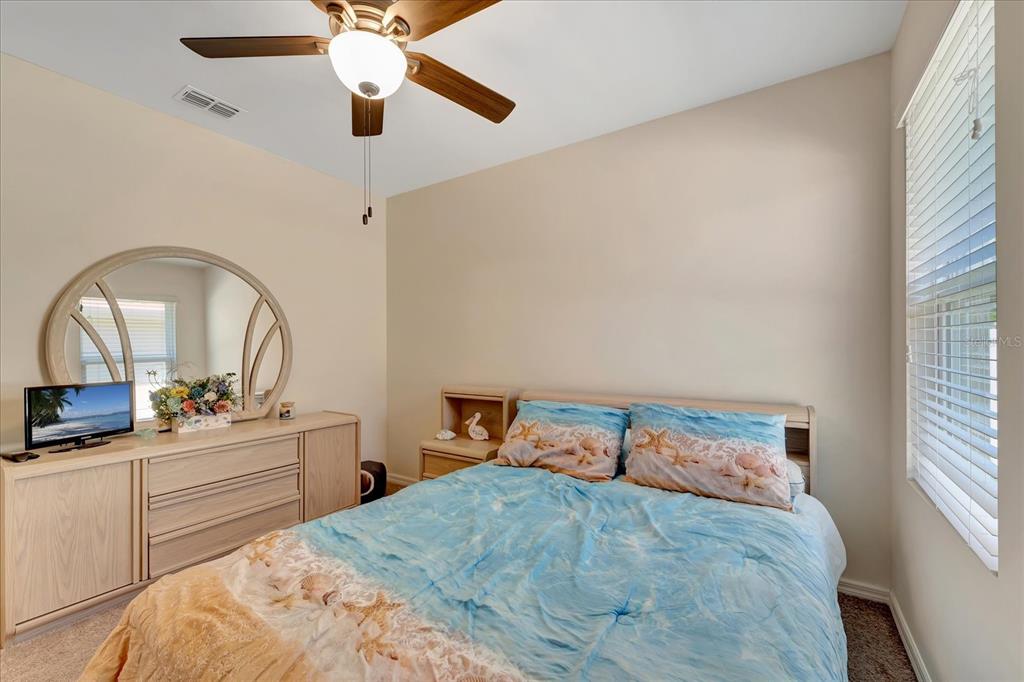 8997 Excelsior Loop Venice, FL 34293 - Photo 30 of 48 a bedroom with a bed and a two windows