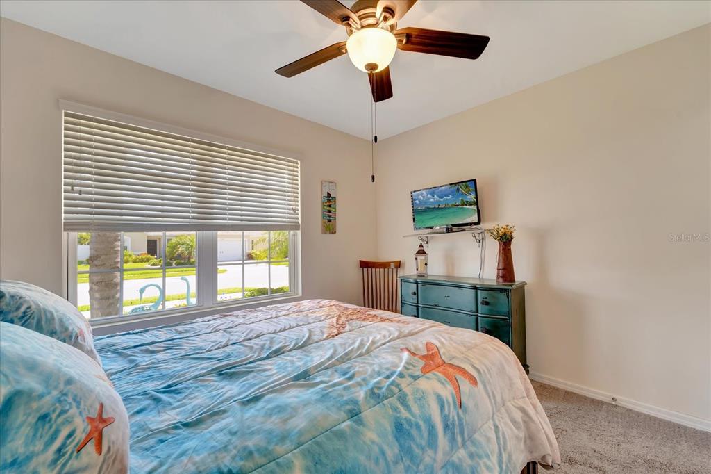 8997 Excelsior Loop Venice, FL 34293 - Photo 32 of 48 a bedroom with a bed and a chandelier