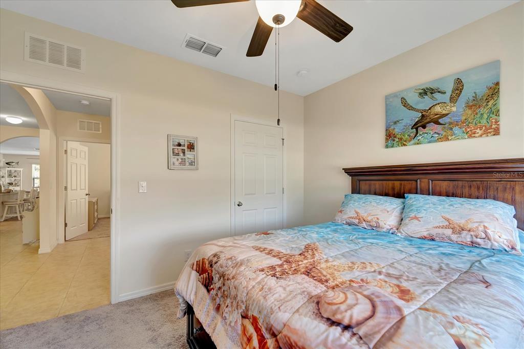 8997 Excelsior Loop Venice, FL 34293 - Photo 33 of 48 a bedroom with a bed and painting on the wall