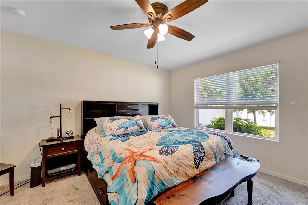 8997 Excelsior Loop Venice, FL 34293 - Photo 35 of 48 a bedroom with a bed and a chandelier