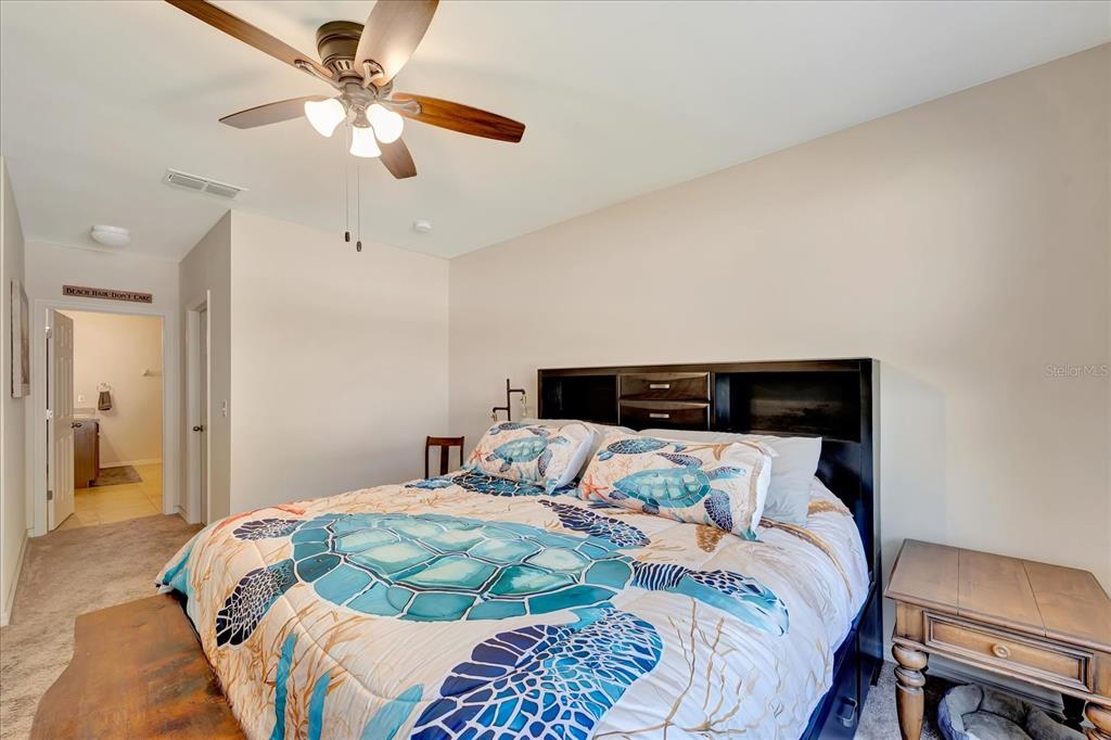 8997 Excelsior Loop Venice, FL 34293 - Photo 36 of 48 a bedroom with a bed and a chandelier