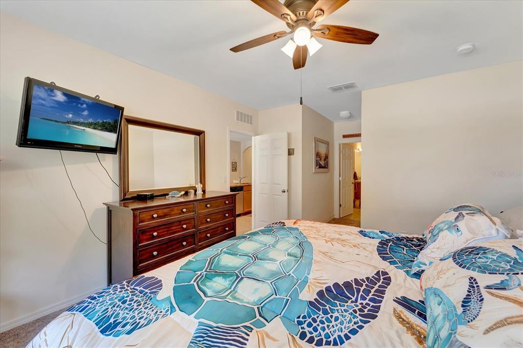8997 Excelsior Loop Venice, FL 34293 - Photo 37 of 48 a bedroom with a bed and a flat screen tv