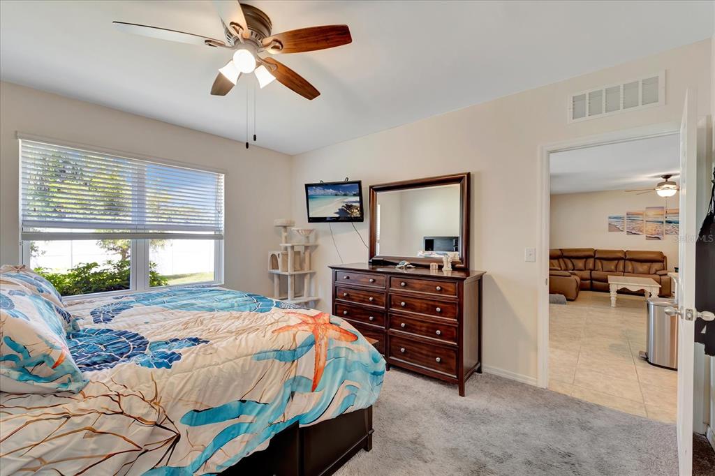 8997 Excelsior Loop Venice, FL 34293 - Photo 38 of 48 a bedroom with a bed and a chandelier