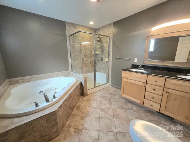 a bathroom with a tub sink and mirror