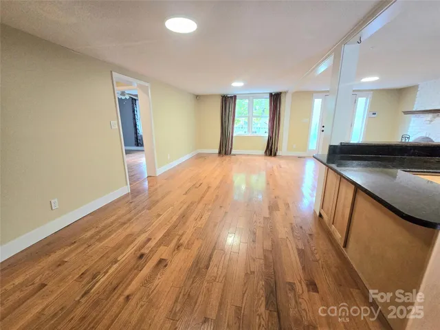 a view of an empty room and wooden floor