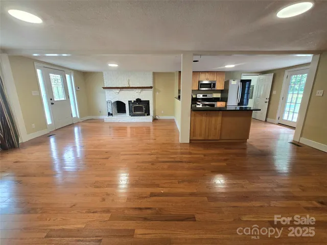 a view of a living room kitchen and a flat screen tv