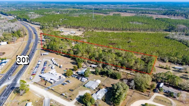 an aerial view of a city with lots of residential buildings ocean and mountain view in back