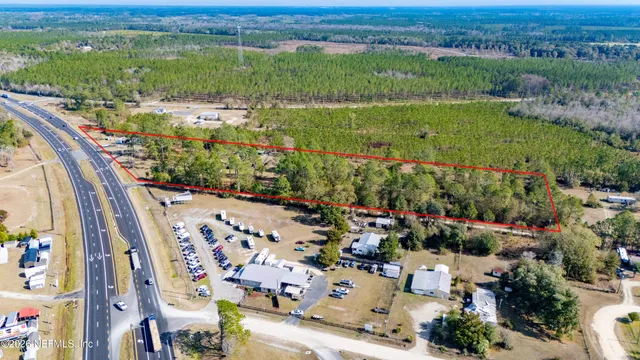 an aerial view of a house with a garden and lake view