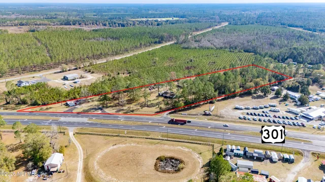an aerial view of a house with a garden and lake view