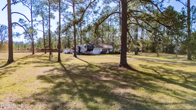 a view of a house with snow on the road