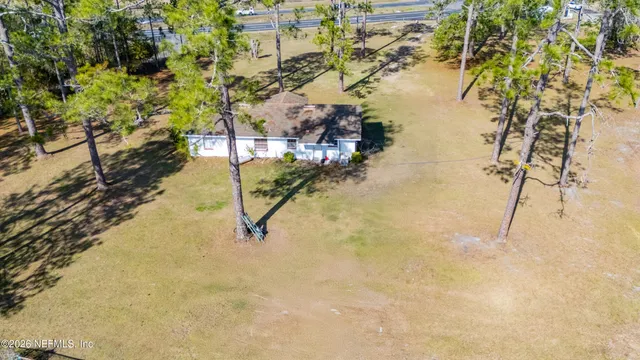 a view of a swimming pool with an outdoor seating and a yard