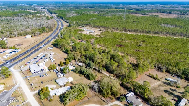 an aerial view of ocean with residential house and outdoor space
