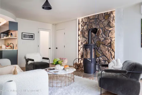 a living room with furniture a window and gym equipment